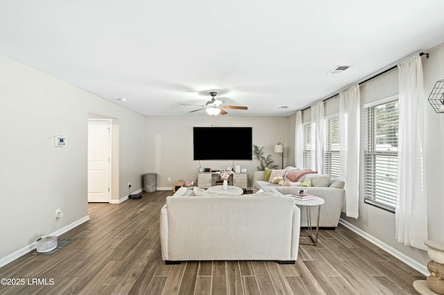 living room featuring ceiling fan and hardwood / wood-style floors