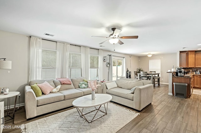 living room featuring hardwood / wood-style flooring and ceiling fan