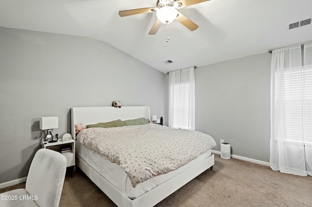 bedroom with lofted ceiling, multiple windows, ceiling fan, and carpet