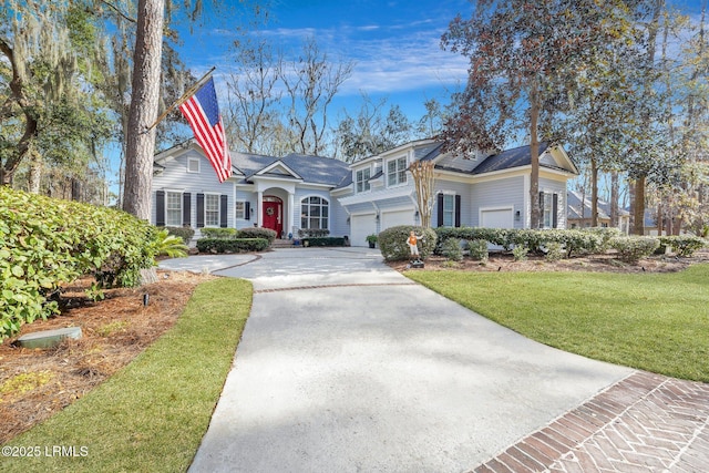 view of front of property with a garage and a front yard