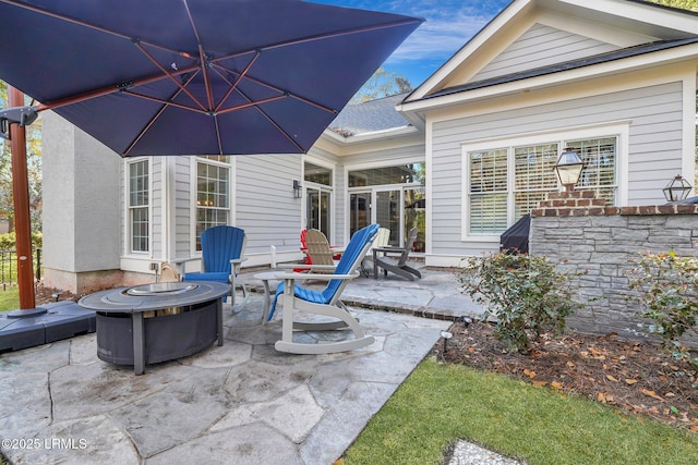 view of patio / terrace featuring an outdoor fire pit