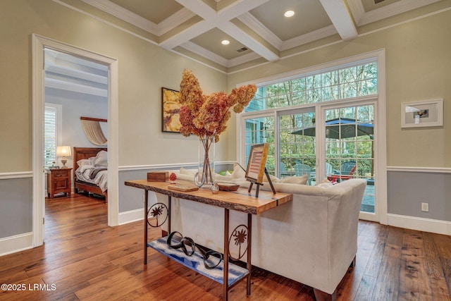 living area featuring coffered ceiling, hardwood / wood-style floors, and beam ceiling