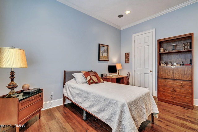 bedroom featuring ornamental molding and light hardwood / wood-style floors