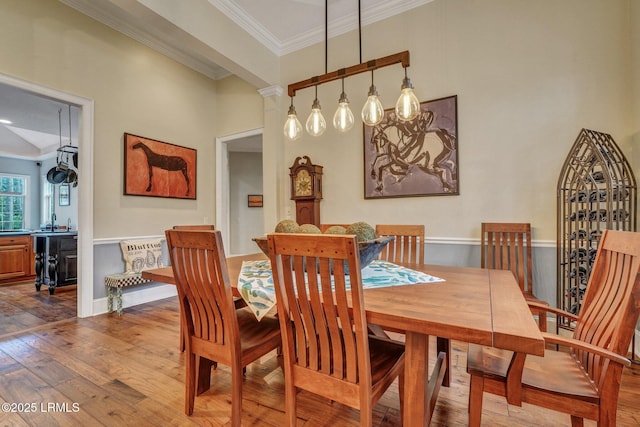 dining room featuring hardwood / wood-style flooring and ornamental molding