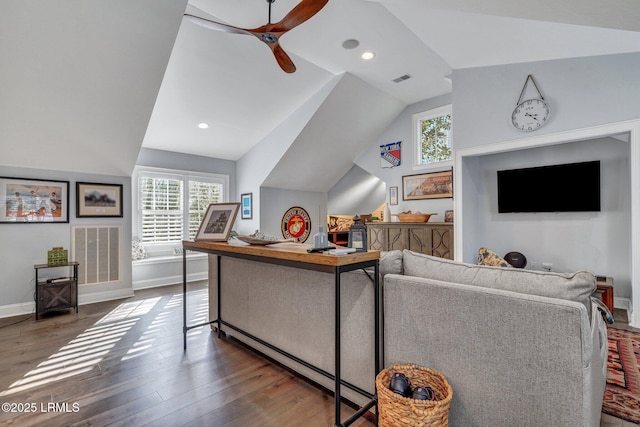 living room with dark wood-type flooring, ceiling fan, and vaulted ceiling