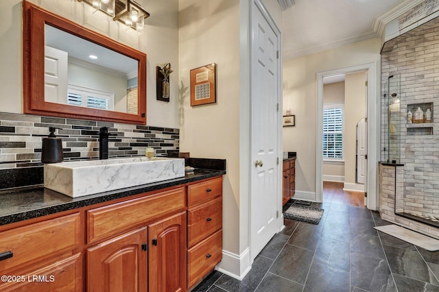 bathroom with vanity, decorative backsplash, a shower with door, and ornamental molding