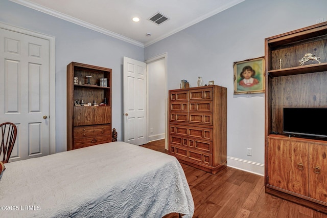 bedroom with ornamental molding and hardwood / wood-style floors