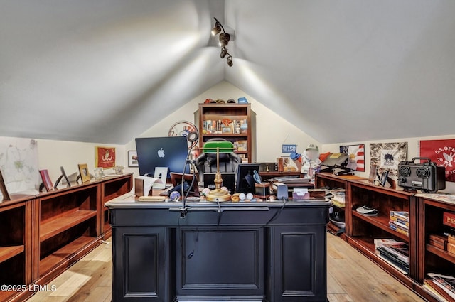 office space featuring lofted ceiling, light hardwood / wood-style flooring, and track lighting