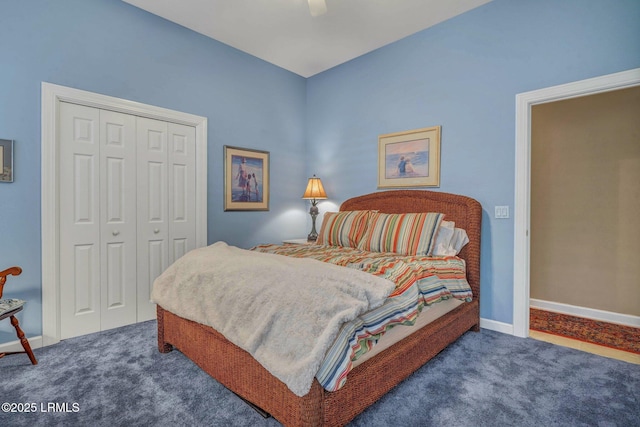 carpeted bedroom featuring a closet and ceiling fan