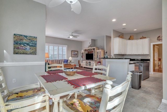 tiled dining space featuring ceiling fan