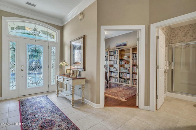 tiled foyer featuring ornamental molding