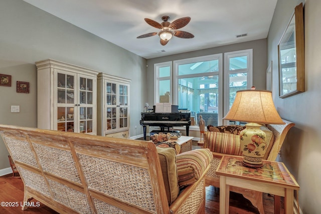 living room featuring wood-type flooring, ceiling fan, and plenty of natural light