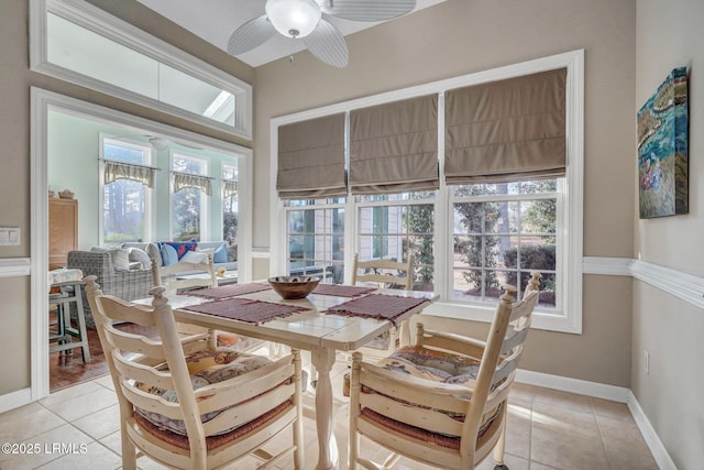 tiled dining space with a wealth of natural light and ceiling fan