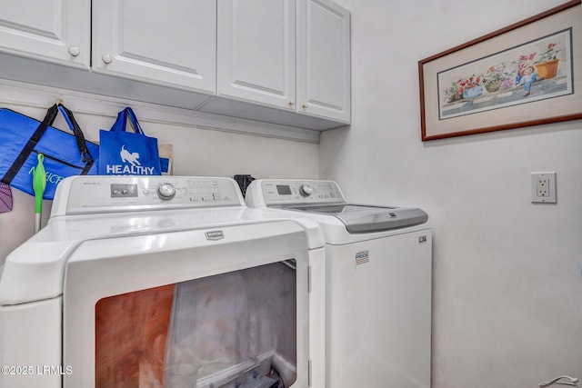 clothes washing area with independent washer and dryer and cabinets