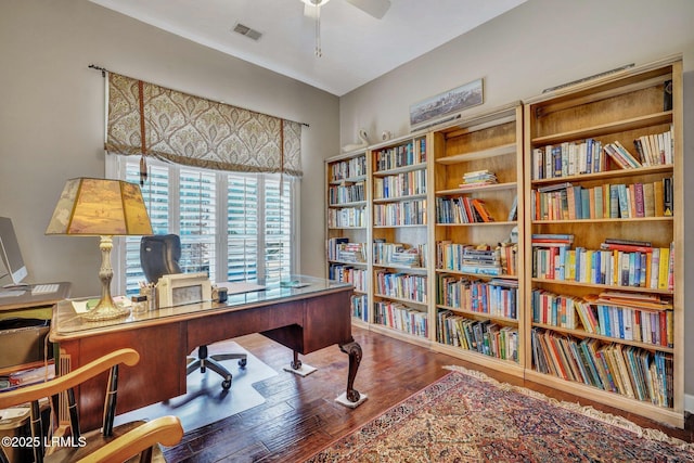 home office with wood-type flooring and ceiling fan