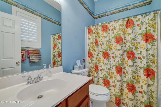 bathroom with vanity, curtained shower, and toilet