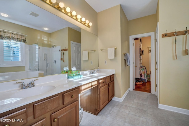 bathroom featuring walk in shower, tile patterned floors, and vanity