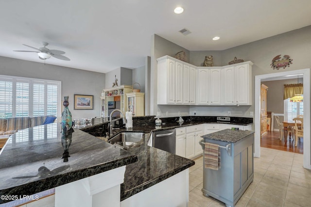 kitchen featuring white cabinetry, sink, and dark stone counters