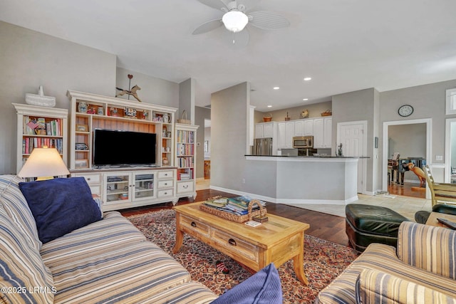 living room with hardwood / wood-style flooring and ceiling fan