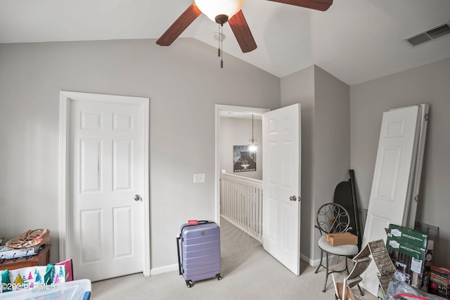 interior space with light colored carpet, visible vents, vaulted ceiling, and baseboards