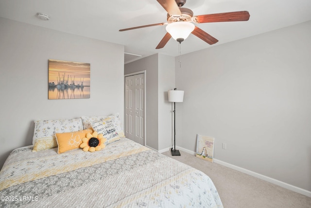 bedroom with a ceiling fan, a closet, baseboards, and carpet flooring