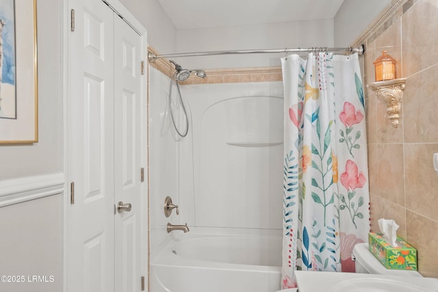 full bathroom with shower / tub combo and a closet