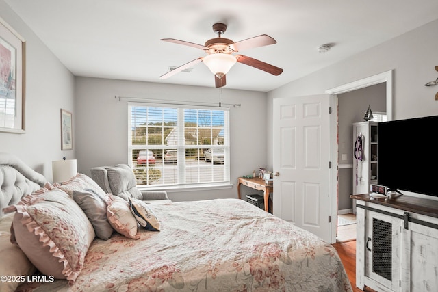 bedroom featuring a ceiling fan and wood finished floors