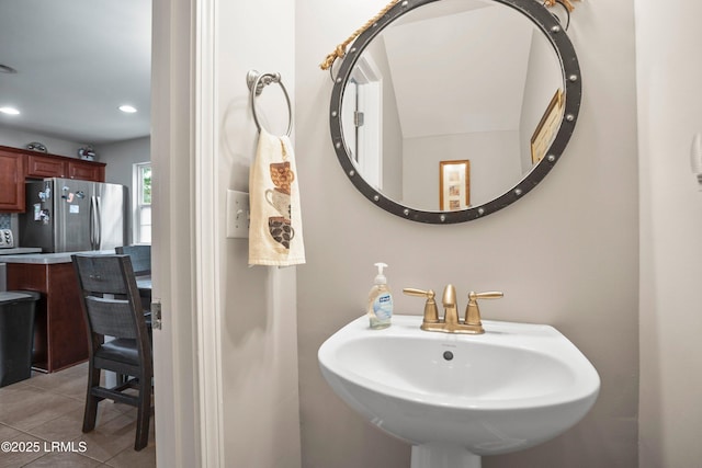 bathroom featuring tile patterned flooring, a sink, and recessed lighting