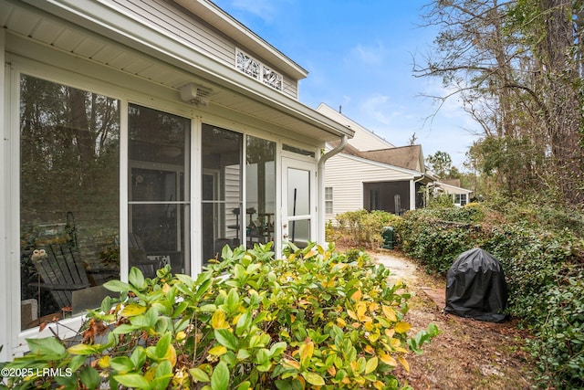 view of side of home featuring a sunroom