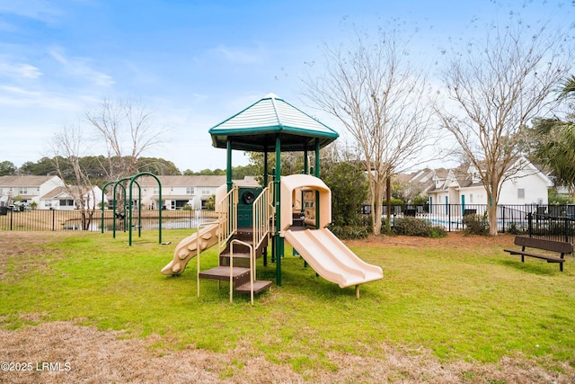 community jungle gym with a yard and fence