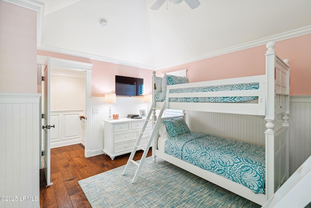 bedroom with dark wood-type flooring, ceiling fan, crown molding, and a towering ceiling