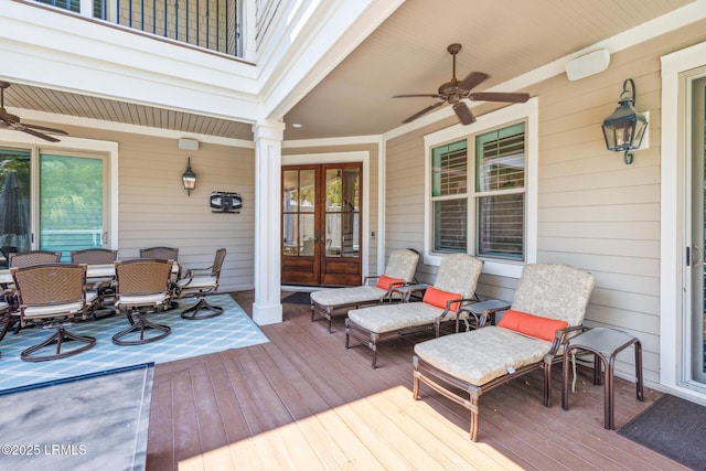 wooden terrace featuring french doors and ceiling fan