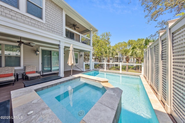 view of swimming pool with an in ground hot tub and ceiling fan