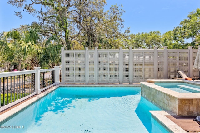 view of swimming pool featuring an in ground hot tub