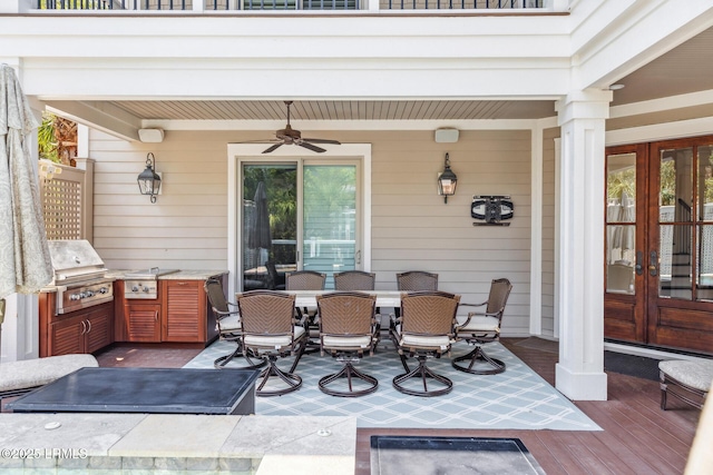 view of patio / terrace featuring grilling area, french doors, ceiling fan, and an outdoor kitchen