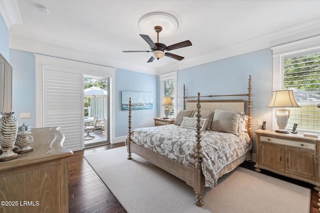 bedroom featuring multiple windows, access to exterior, dark hardwood / wood-style flooring, and ornamental molding