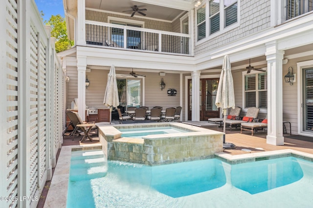 view of pool with a patio area, ceiling fan, and an in ground hot tub