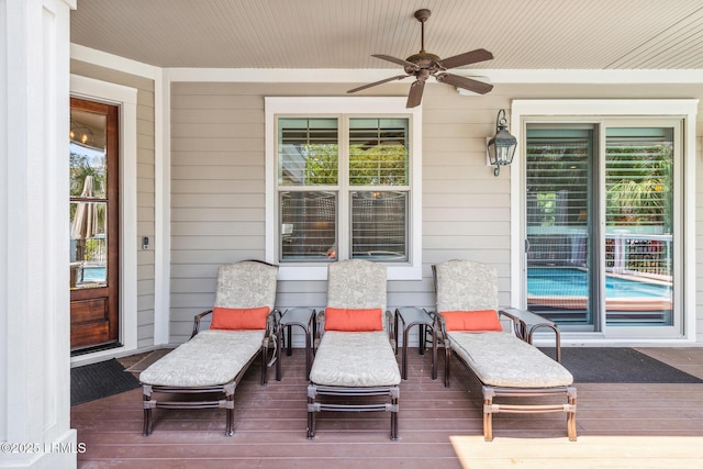 wooden terrace with ceiling fan and a porch