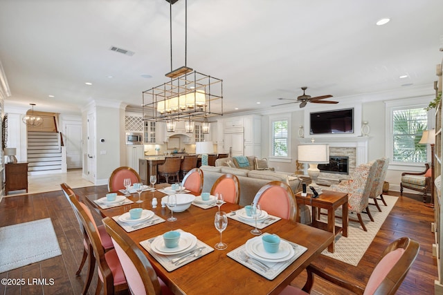 dining space featuring ceiling fan, ornamental molding, and dark hardwood / wood-style floors