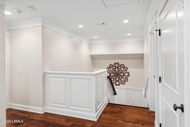 corridor with dark hardwood / wood-style flooring and ornamental molding