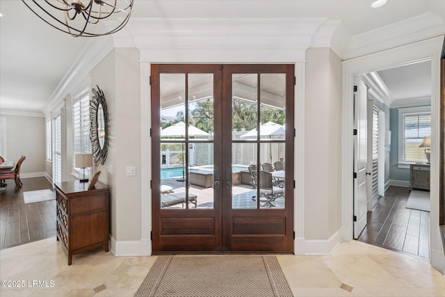 doorway to outside with ornamental molding, plenty of natural light, and french doors