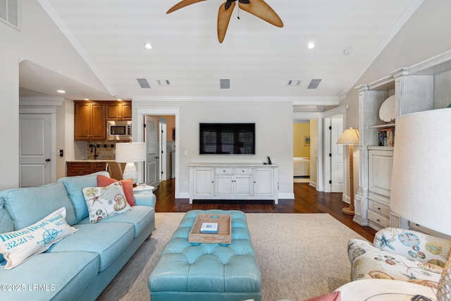 living room featuring crown molding, ceiling fan, vaulted ceiling, and dark wood-type flooring