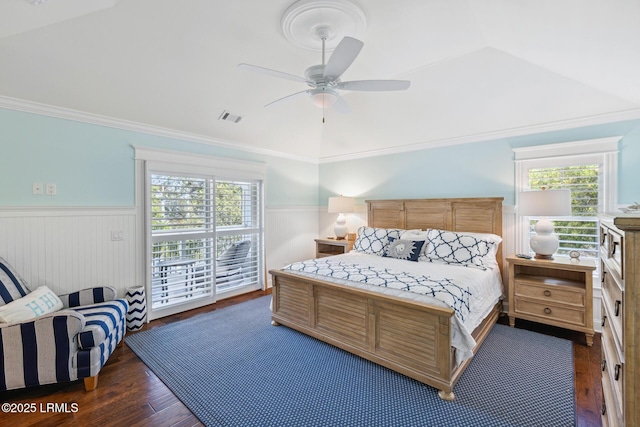 bedroom featuring multiple windows, ornamental molding, dark hardwood / wood-style floors, and ceiling fan