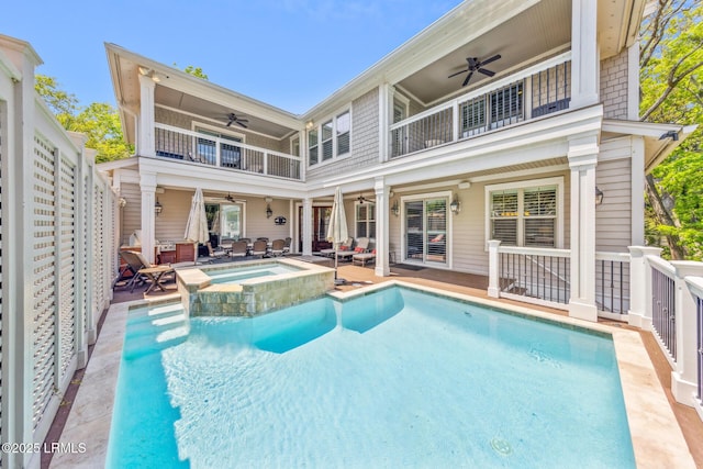 rear view of house featuring a swimming pool with hot tub, ceiling fan, and a balcony