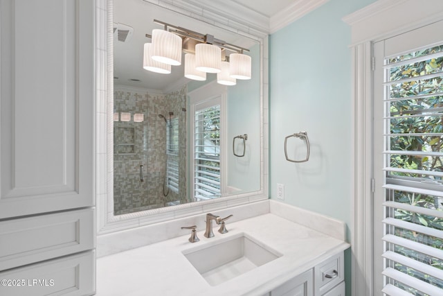 bathroom with a shower with door, crown molding, and vanity