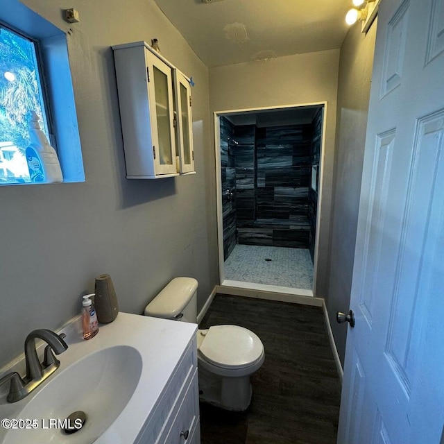 907 Duke St, Beaufort, SC 29902 - bathroom featuring toilet, wood finished floors, tiled shower, and vanity