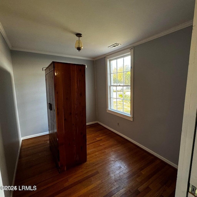 907 Duke St, Beaufort, SC 29902 - unfurnished bedroom with visible vents, crown molding, and wood finished floors