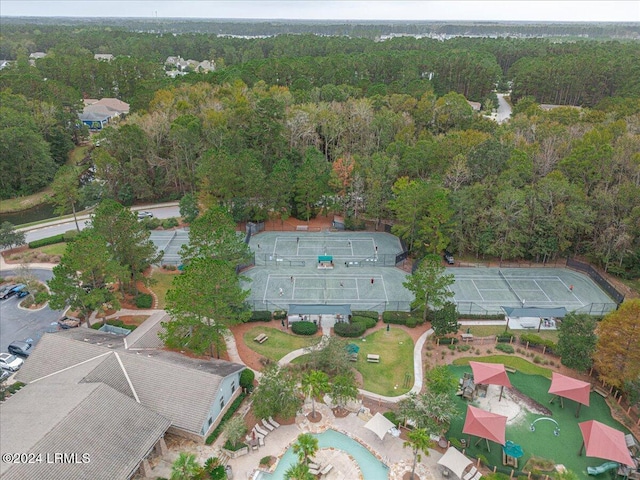 drone / aerial view with a wooded view