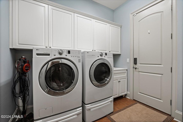 laundry area featuring washer and dryer and cabinets