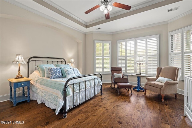 bedroom featuring crown molding, dark wood-type flooring, a raised ceiling, and ceiling fan